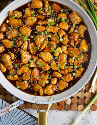 A skillet is filled with sesame chicken.