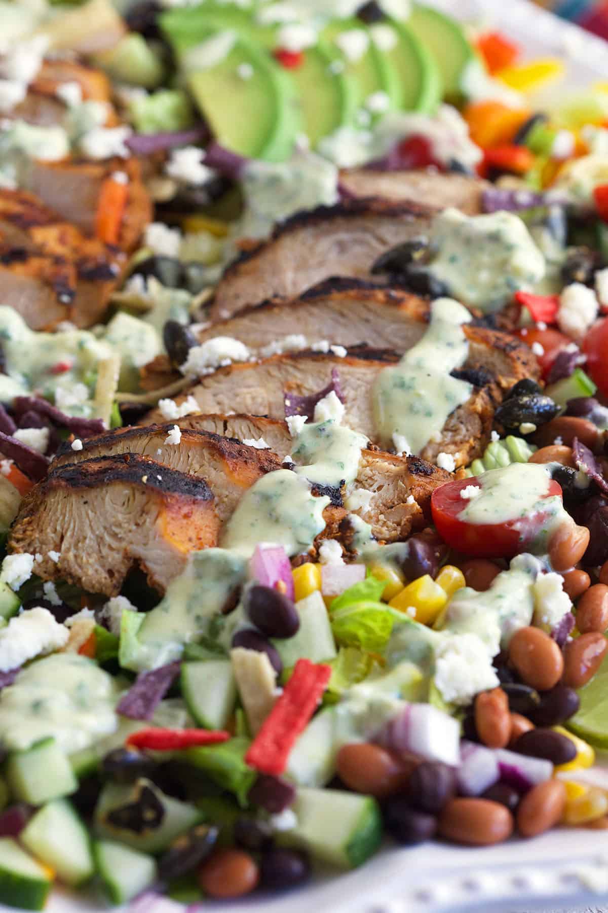 Cilantro lime dressing is drizzled across the top of southwest chicken salad. 
