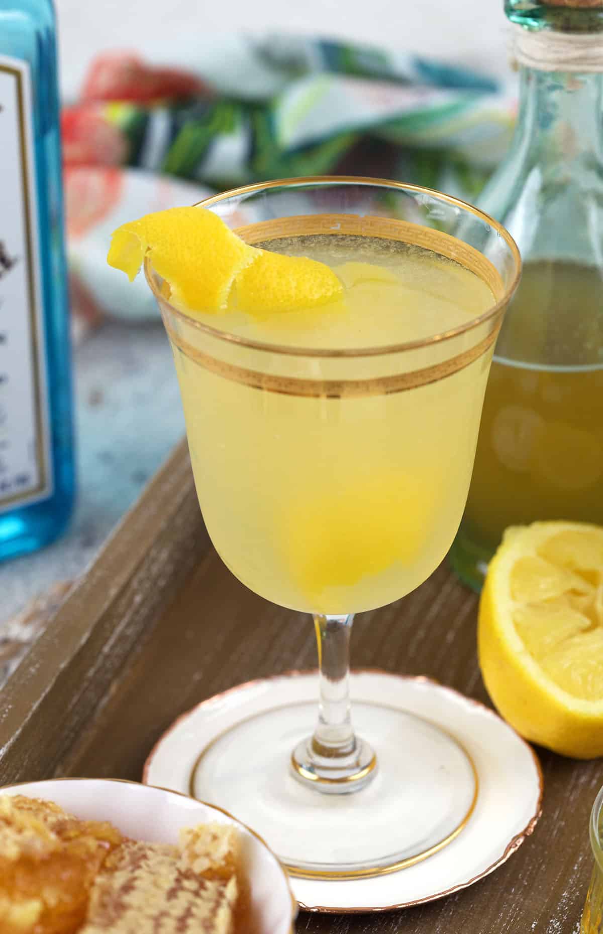 A lemon twist is garnishing a single glass. 