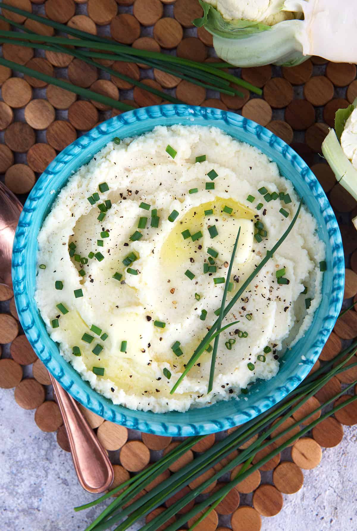 A blue bowl is filled with cauliflower mash. 