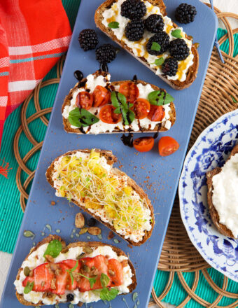 Four pieces of cottage cheese toast are placed on a blue platter.