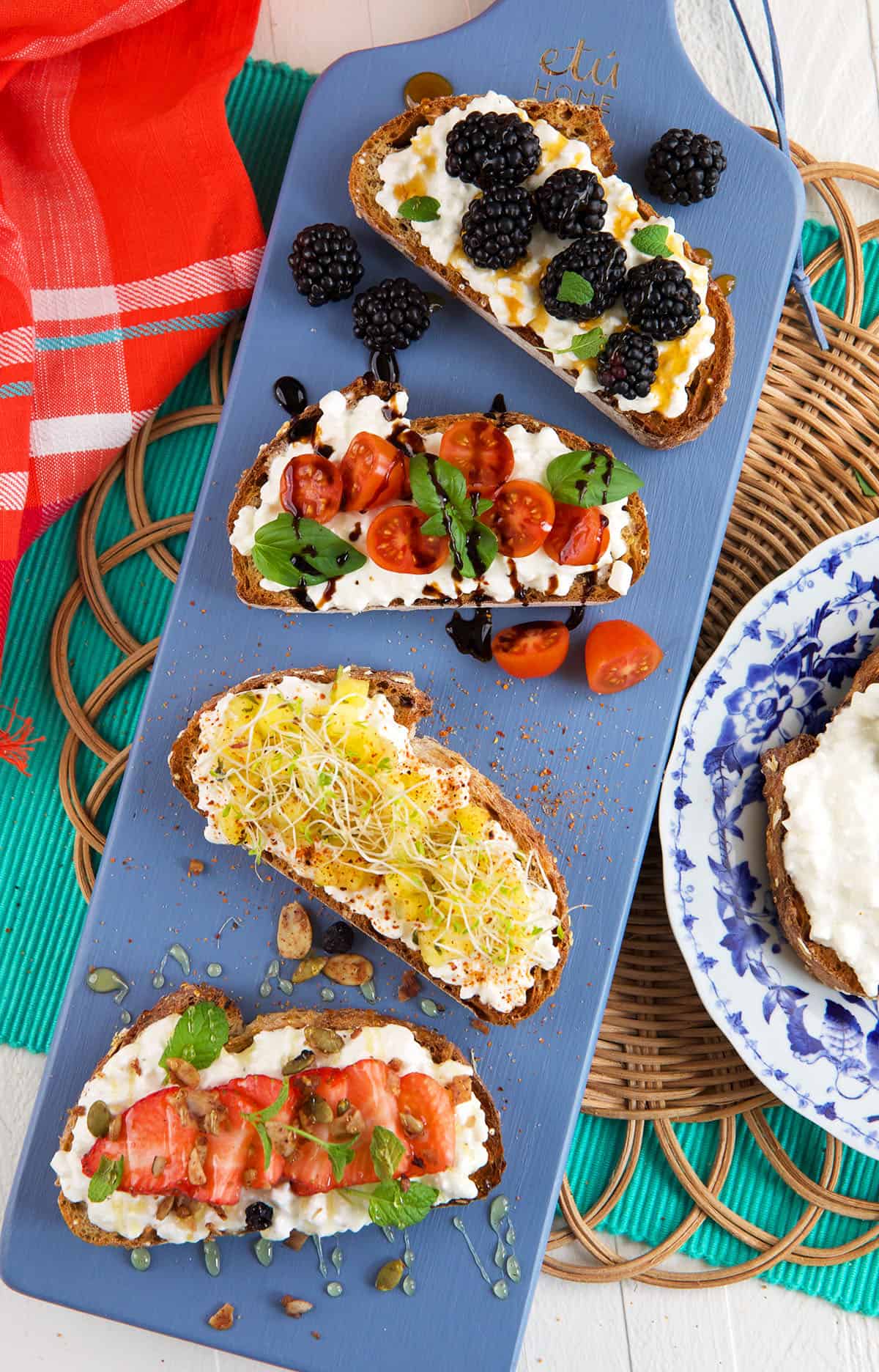 Four pieces of cottage cheese toast are placed on a blue platter. 