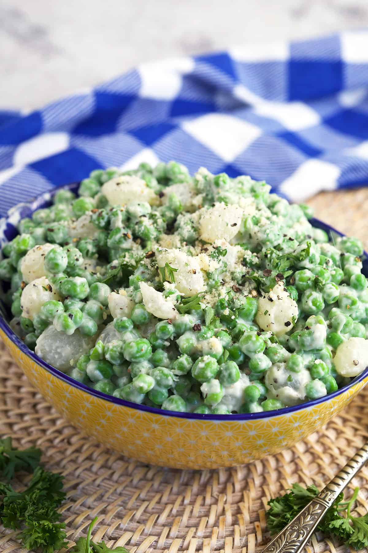A yellow bowl is filled with creamed peas. 