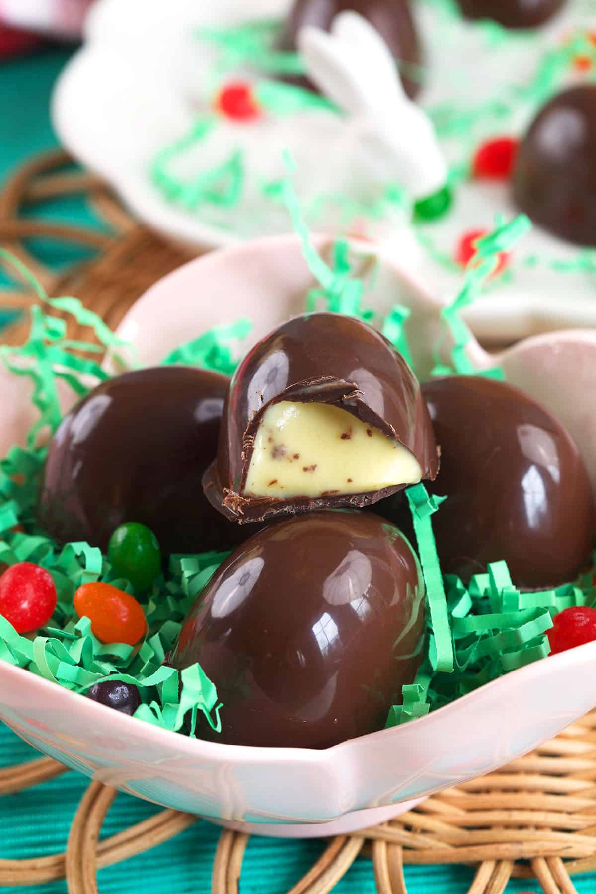 Chocolate Creme Brulee Eggs in a pink bowl with easter grass and jelly beans.