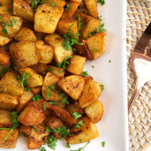 Potatoes are garnished with fresh herbs.