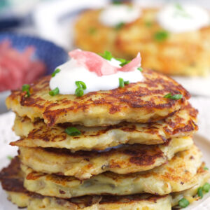 A stack of irish potato pancakes are on a plate.