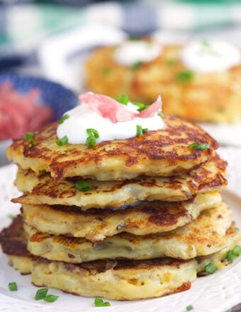 A stack of irish potato pancakes are on a plate.