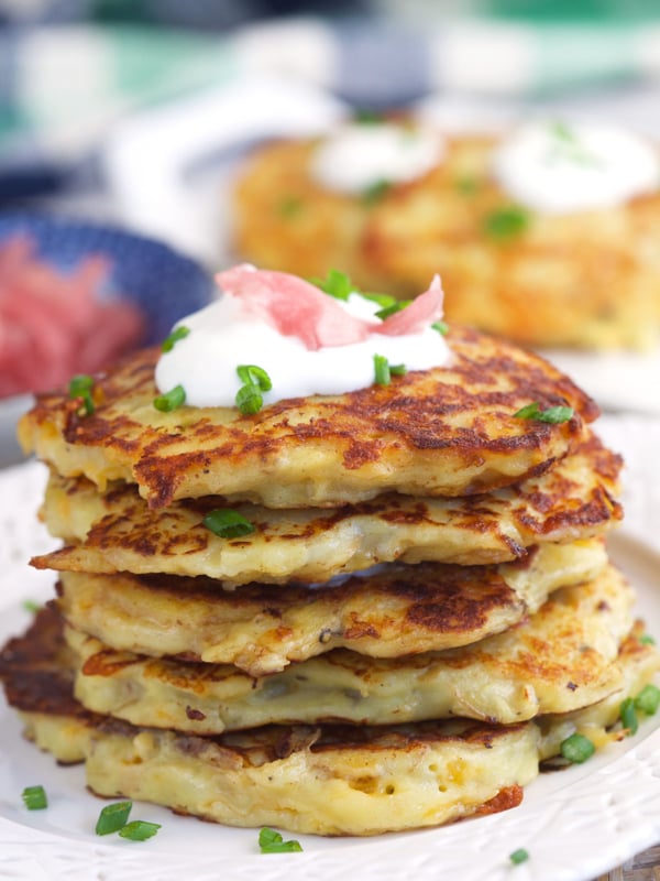A stack of irish potato pancakes are on a plate.