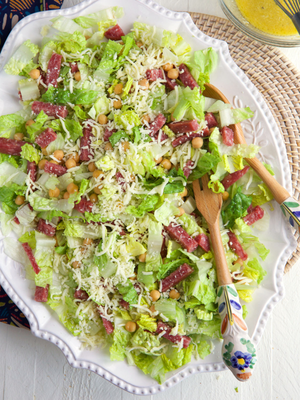 A large white serving plate is topped with la scala salad.
