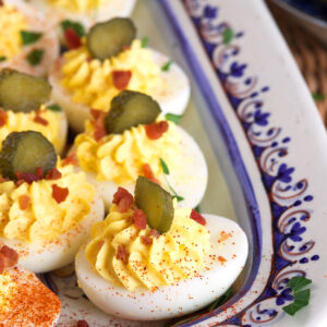 Pickles, paprika and bacon garnish deviled eggs.
