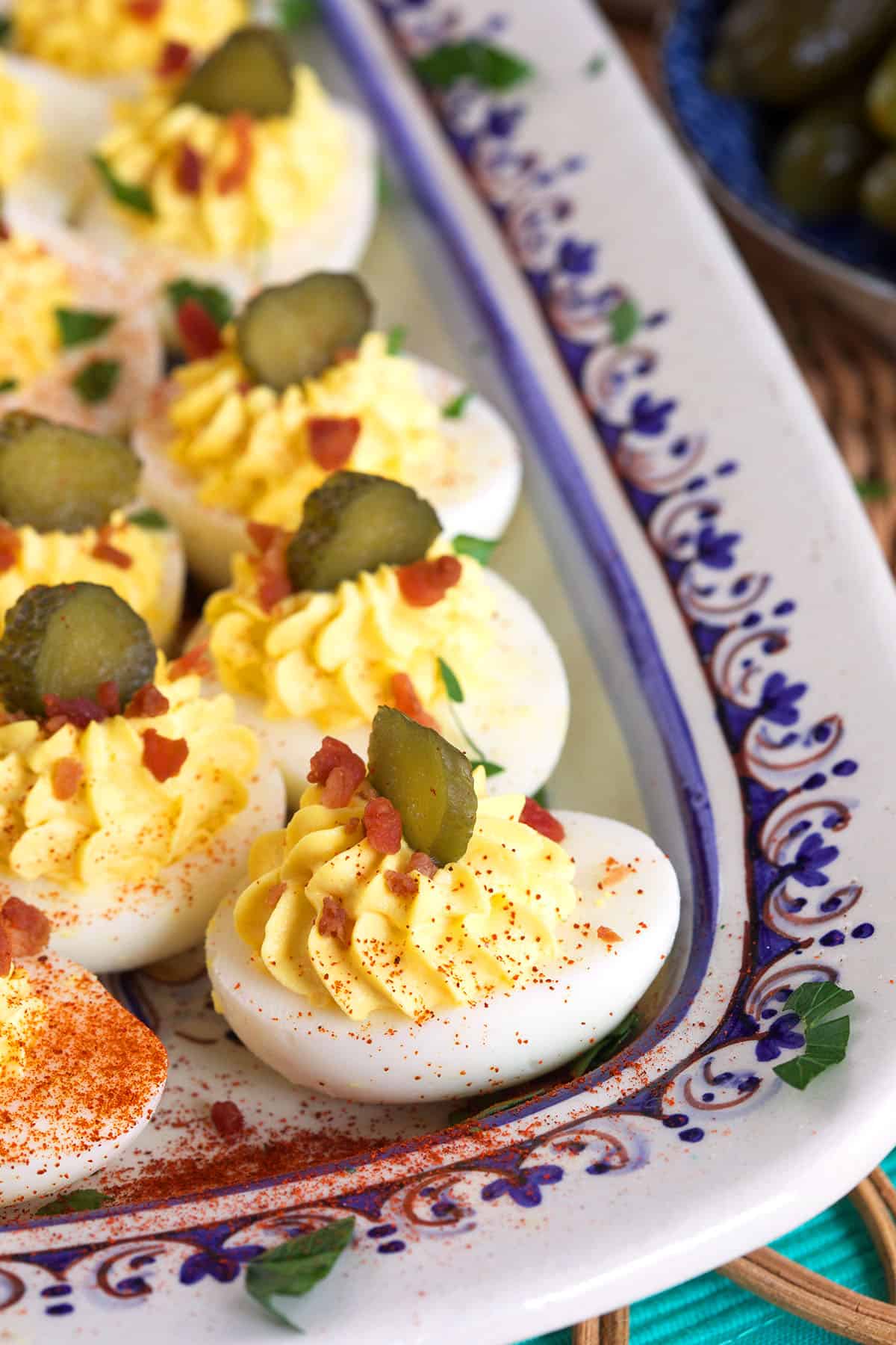 Pickles, paprika and bacon garnish deviled eggs. 