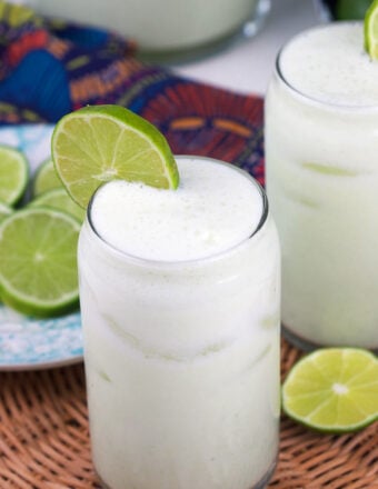 A slice of lime garnishes a glass of lemonade.