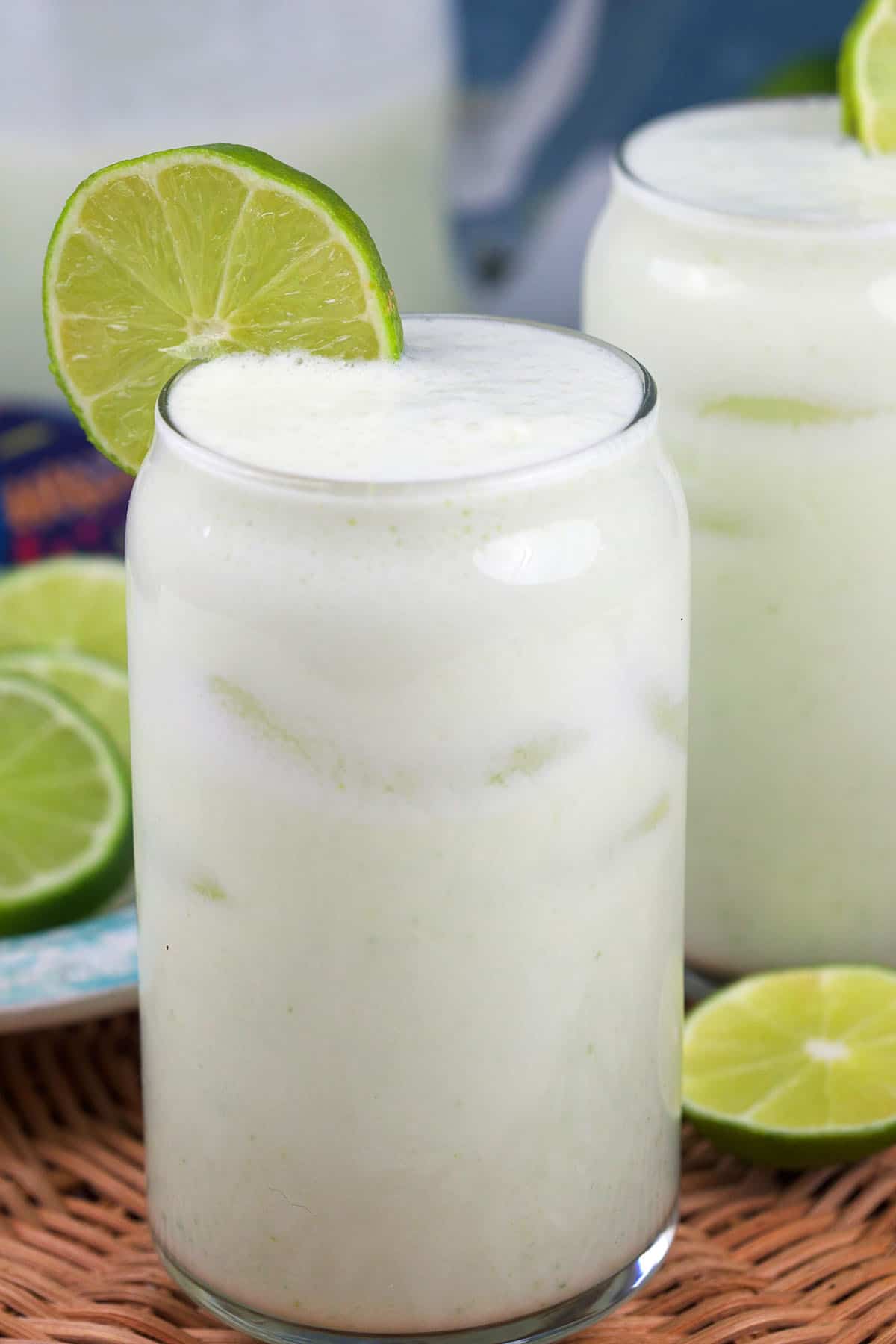 A tall glass is filled with Brazilian lemonade. 