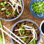Two egg roll bowls are placed next to each others.