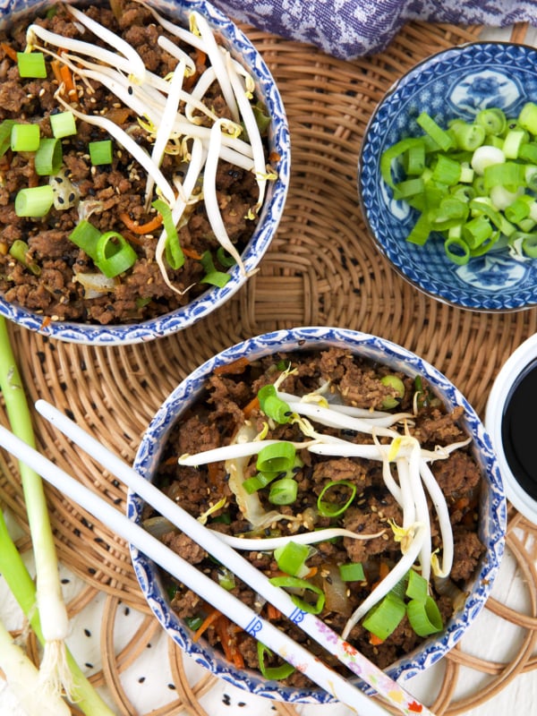 Two egg roll bowls are placed next to each others.