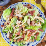 A round plate is topped with salad.