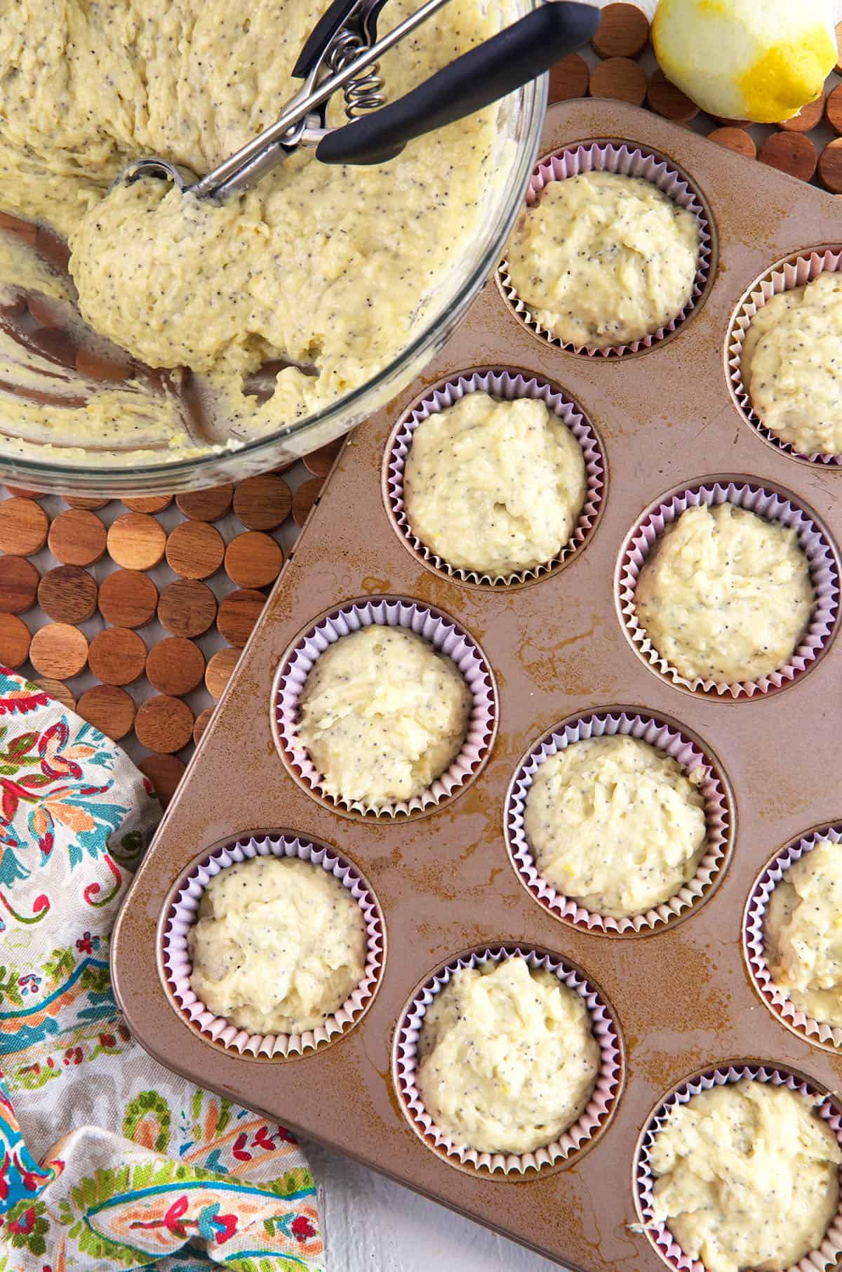 Muffin tins are filled with muffin batter. 