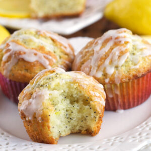 A bite has been taken out of a lemon poppy seed muffin.