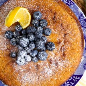 Blueberries, lemons and powdered sugar top a lemon ricotta cake.