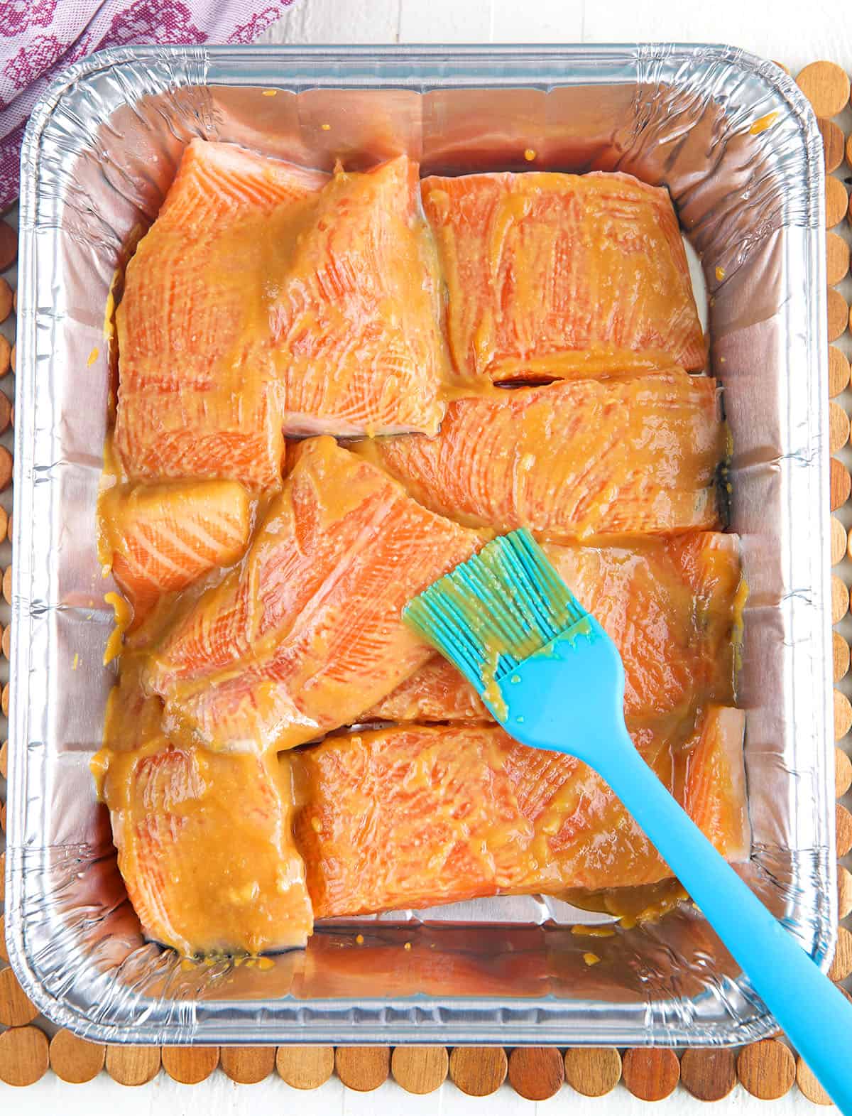 A rubber brush has coated the salmon in glaze. 