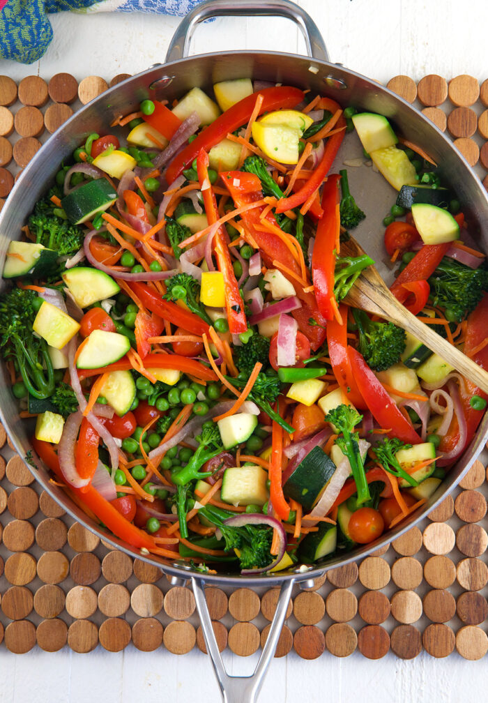 vegetables for pasta primavera in a large skillet being sautéed.