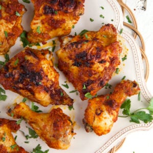 A batch of peri peri chicken is presented on a serving platter.