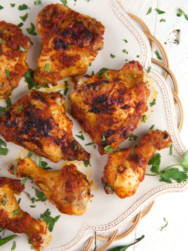 A batch of peri peri chicken is presented on a serving platter.