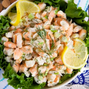 A large white bowl is filled with shrimp salad.