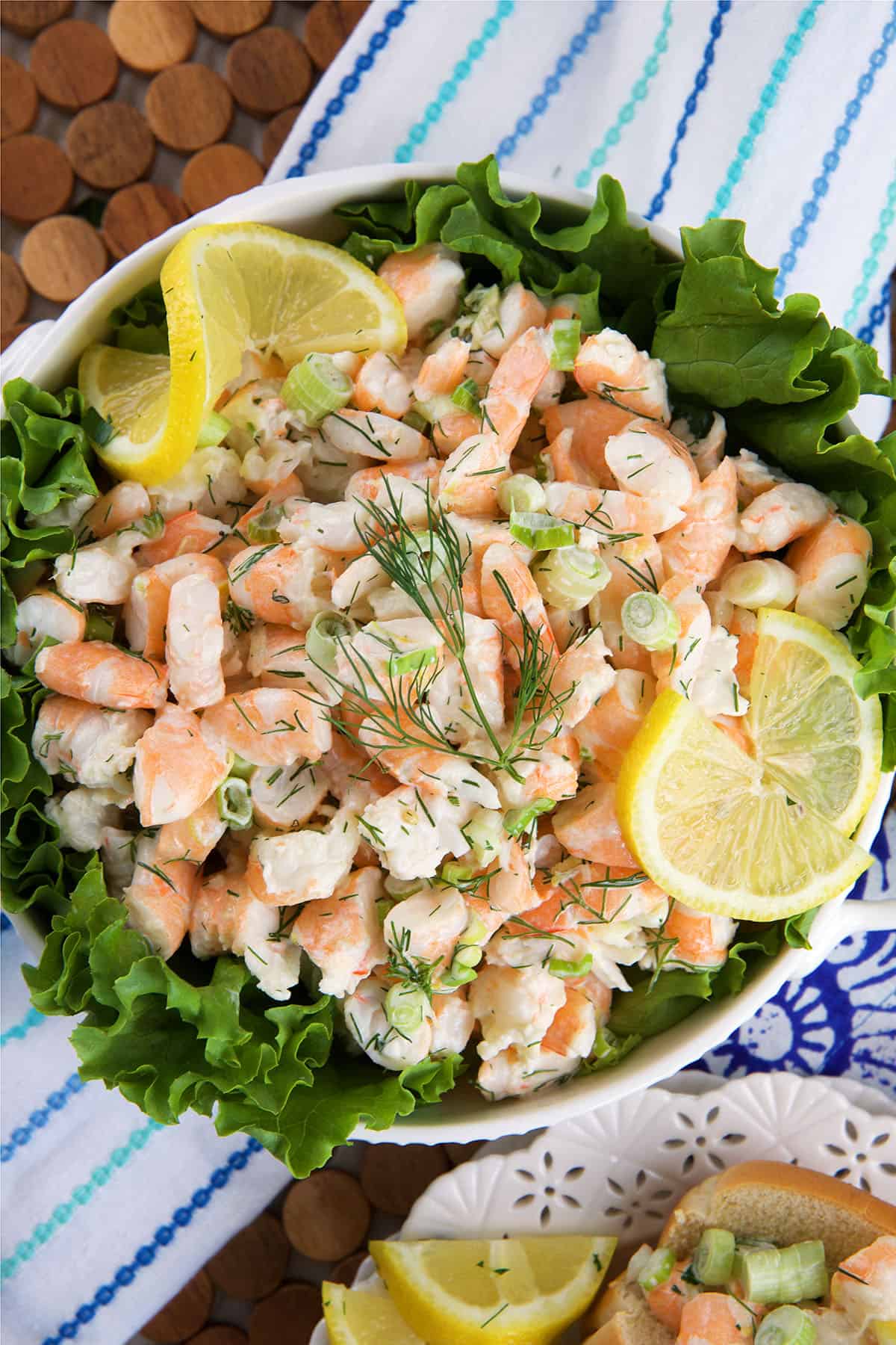 A large white bowl is filled with shrimp salad. 