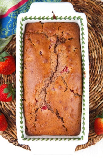 A loaf pan is presented with baked strawberry bread.
