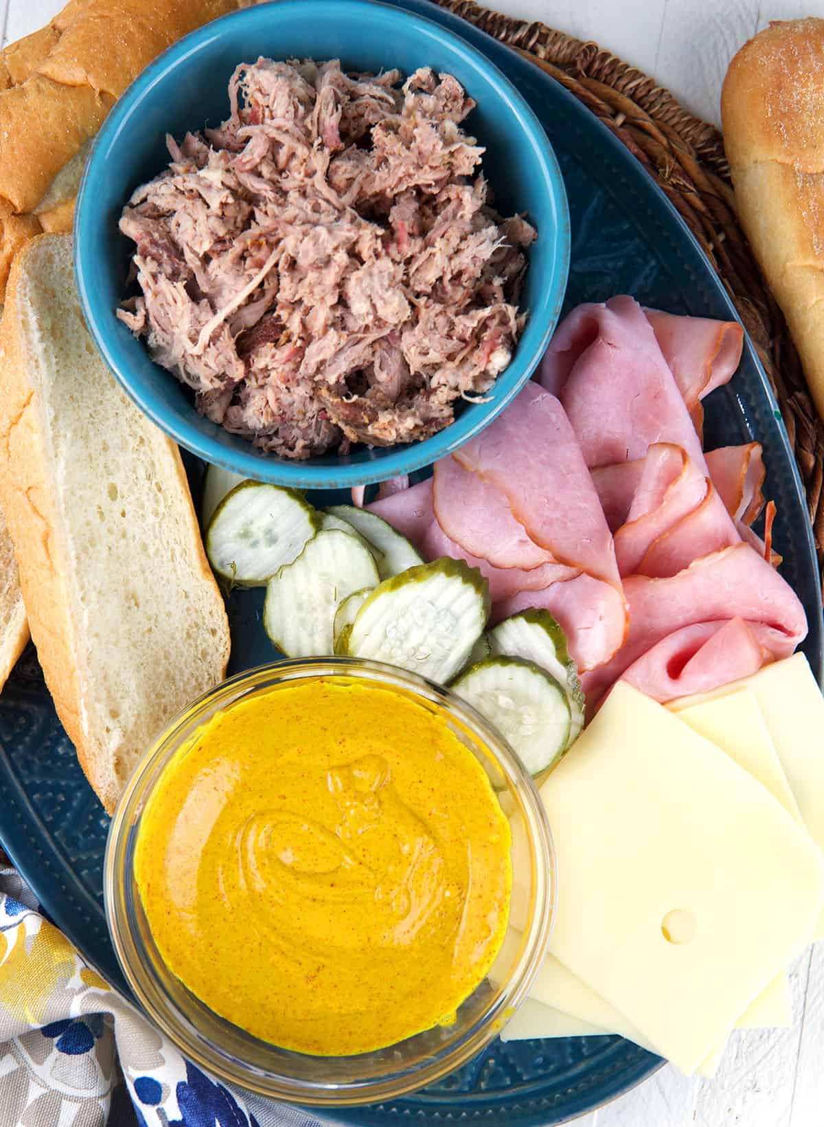 The ingredients for a cuban sandwich are spread out. 