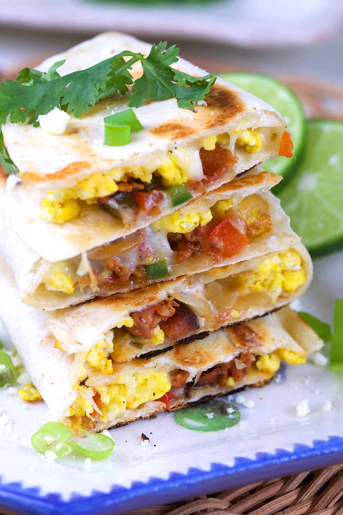 A stack of breakfast quesadillas are on a plate.