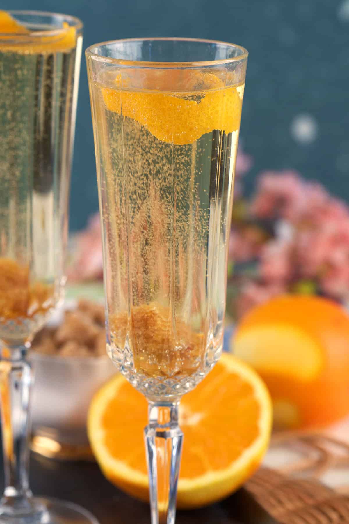A citrus twist garnishes a glass of champagne cocktail. 
