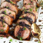 A spoon is placed next to sliced tenderloin.