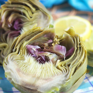 An artichoke is sliced to reveal a fully cooked center.