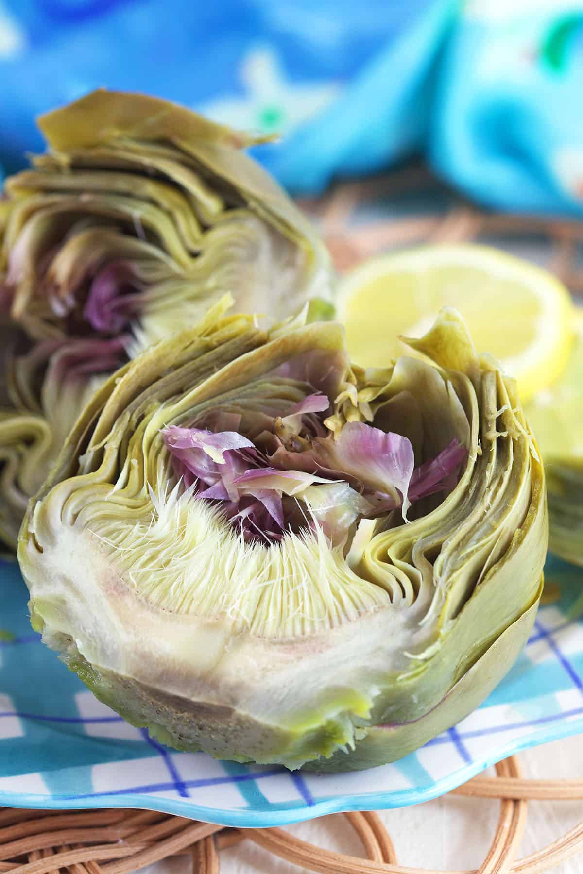 An artichoke is sliced to reveal a fully cooked center. 