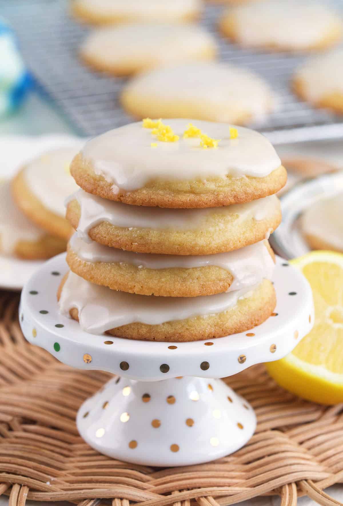 A stack of cookies is presented on a small cake stand. 