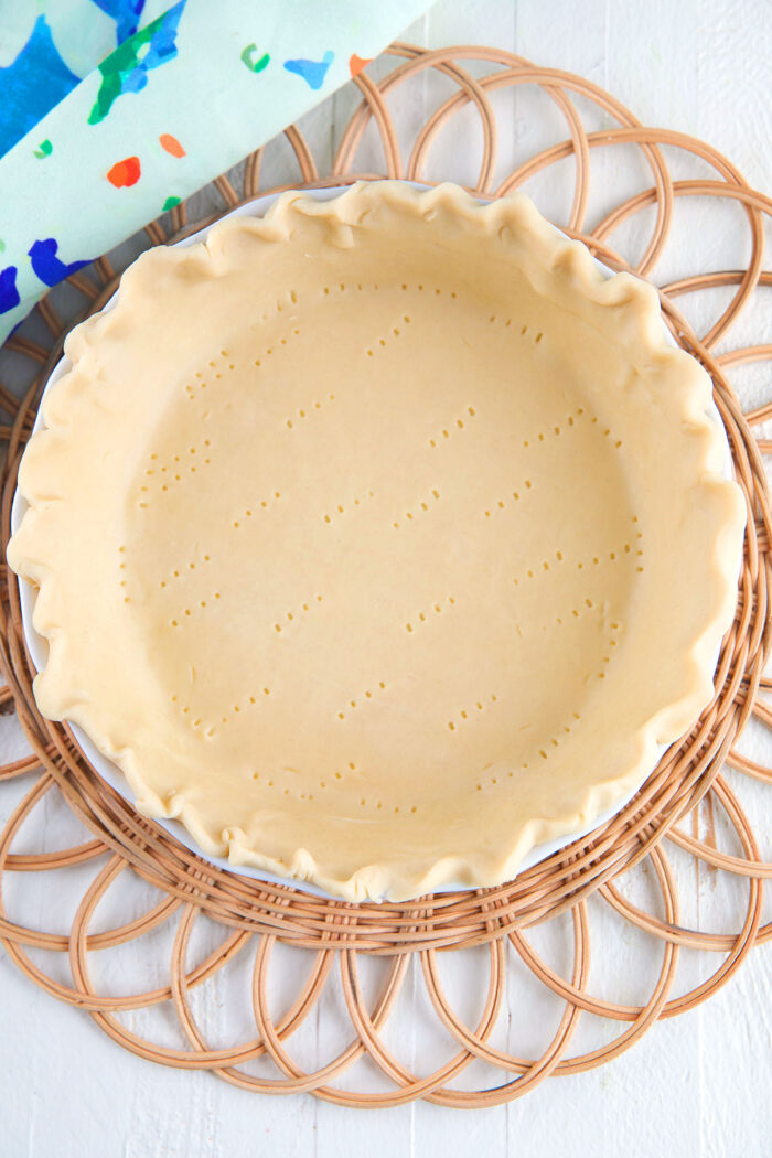 A pie crust has been pierced by a fork. 