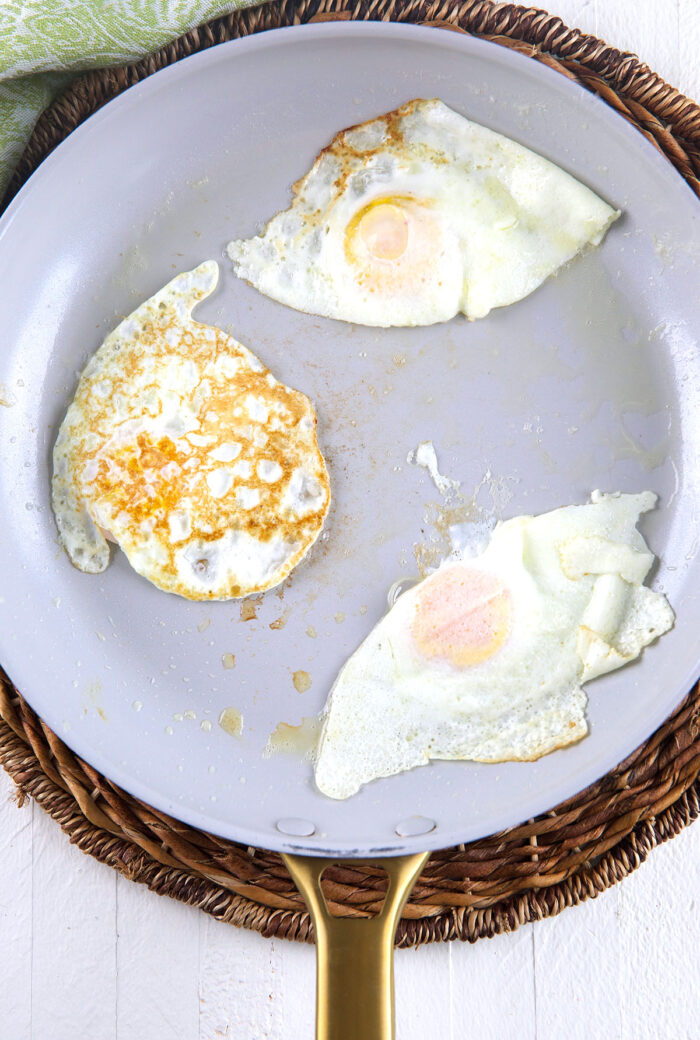 Cooked eggs are in a skillet. 