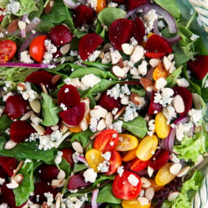 A large bowl is filled with spring mix salad.