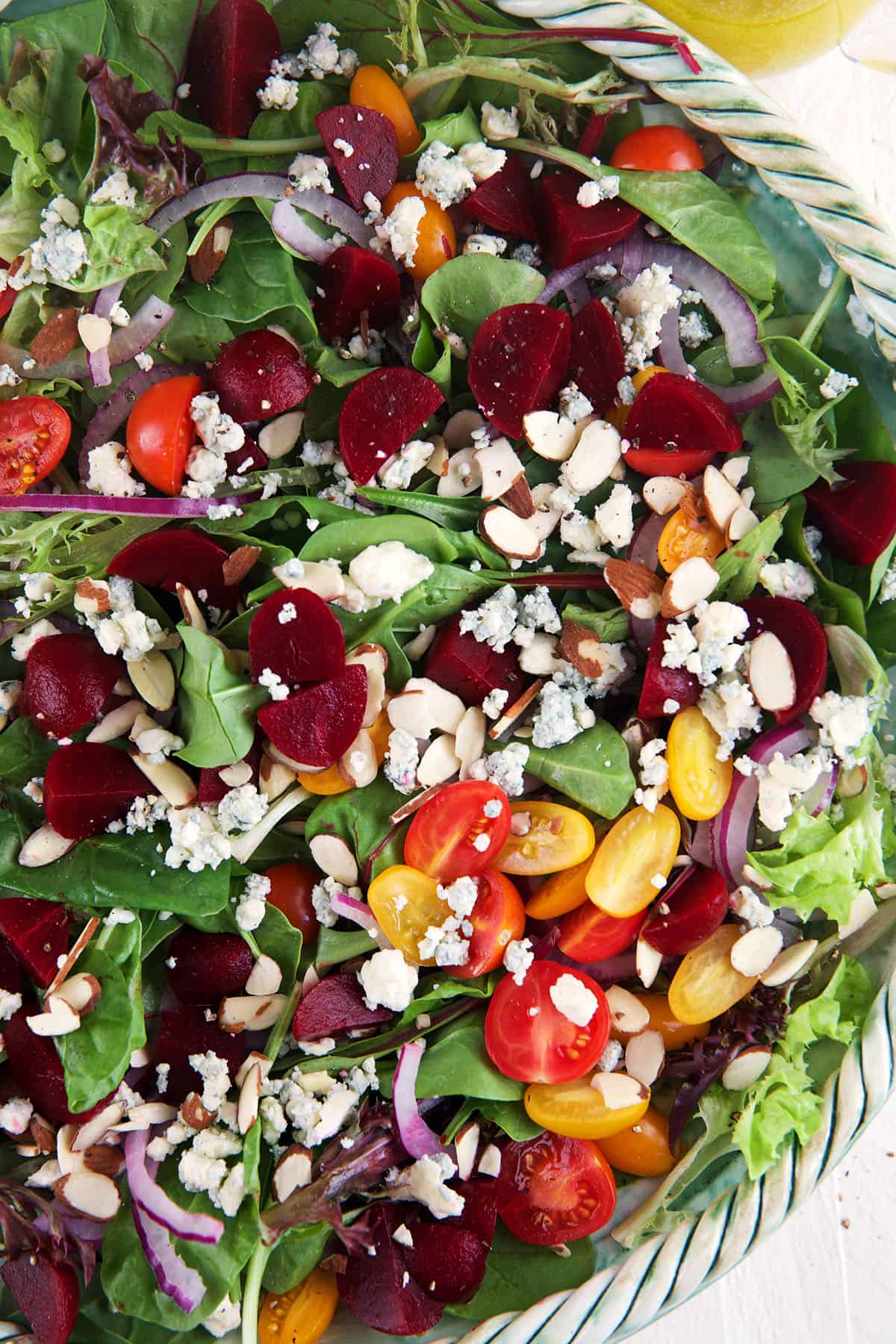 A large bowl is filled with spring mix salad. 
