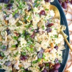 A large blue serving platter is topped with pasta salad.