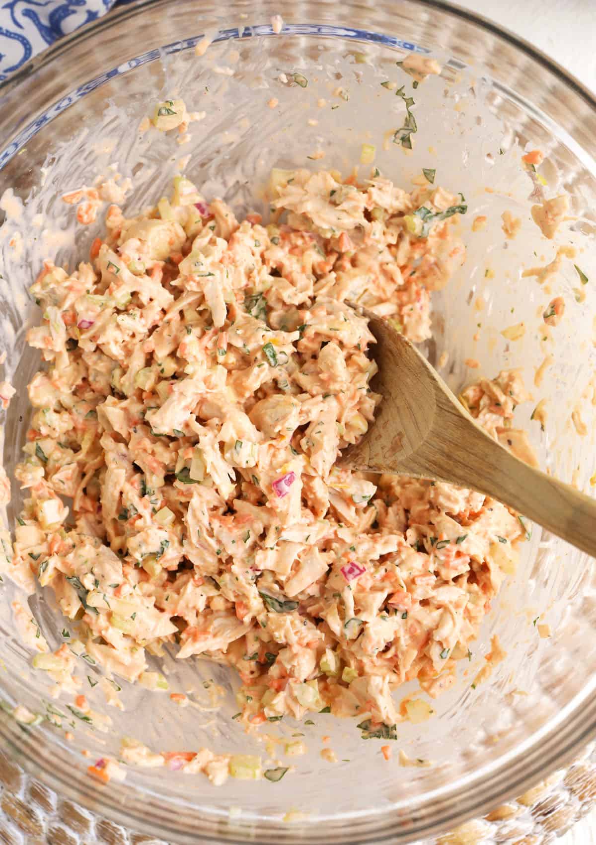 A chicken salad has been mixed together in a large bowl. 