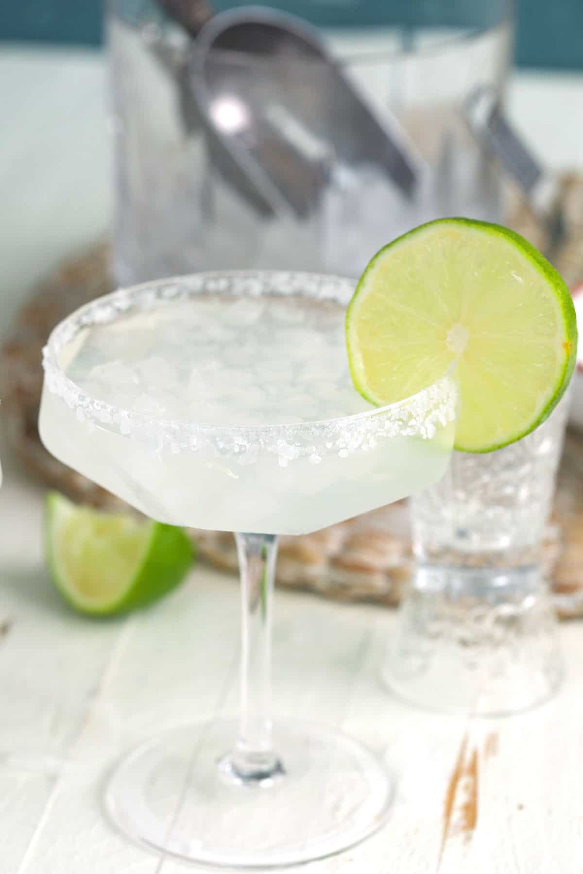 A cadillac margarita is garnished with a lime wedge. 