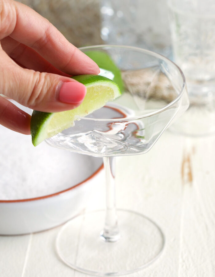 A lime is being used to rim the glass.