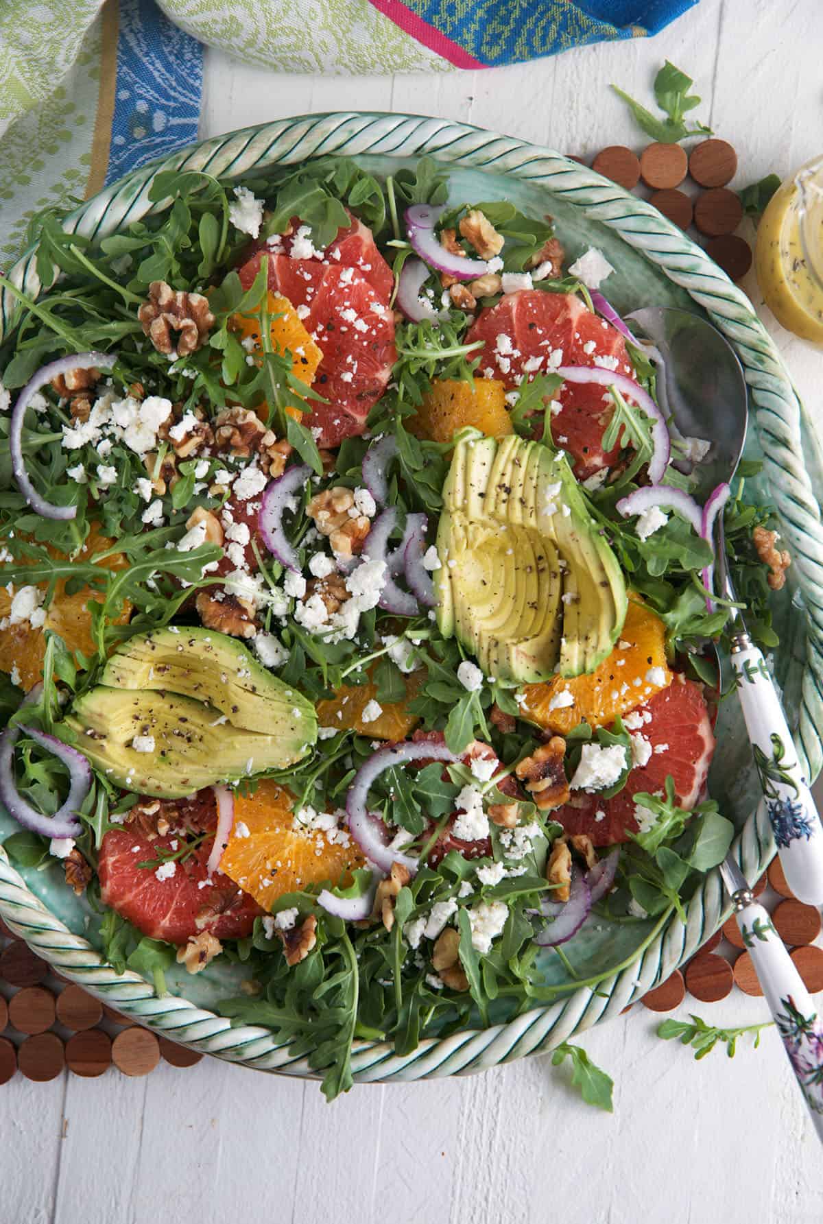 A big bowl is filled with citrus avocado salad. 