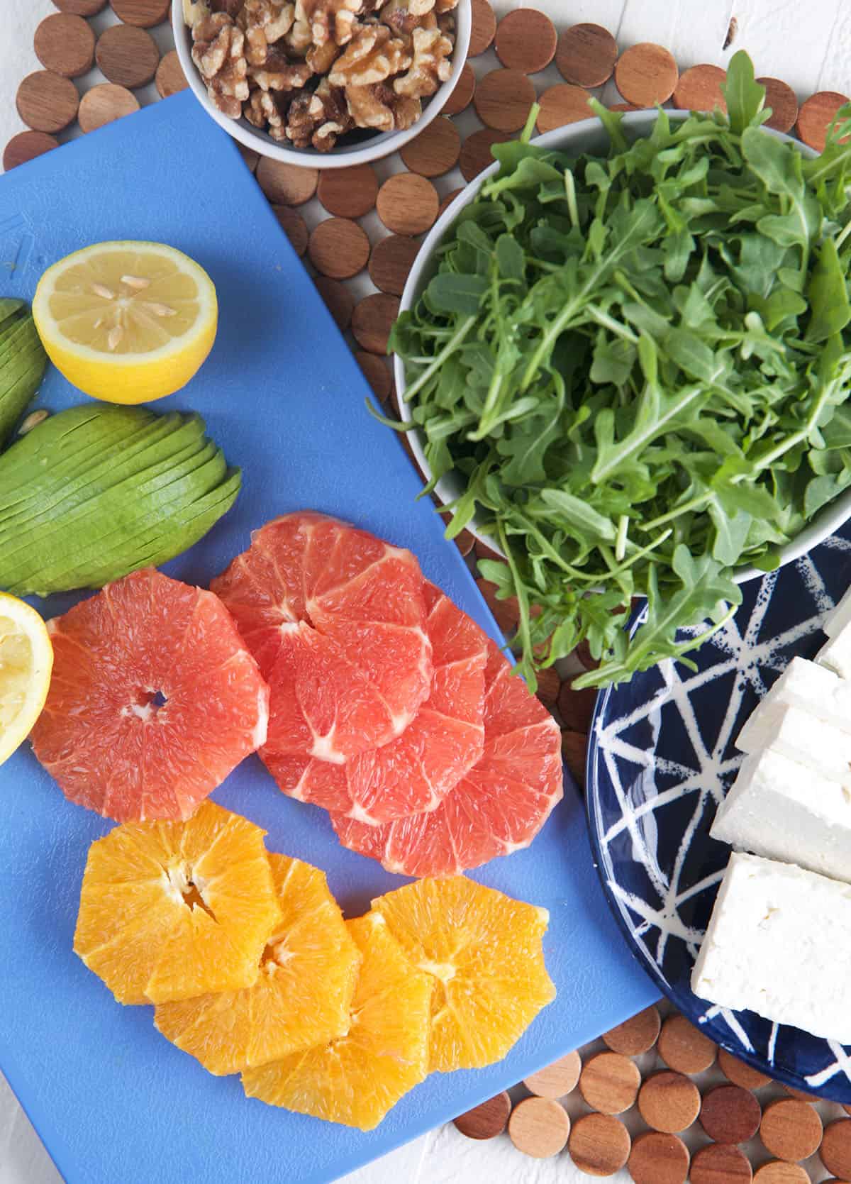 The ingredients for citrus avocado salad are spread out. 