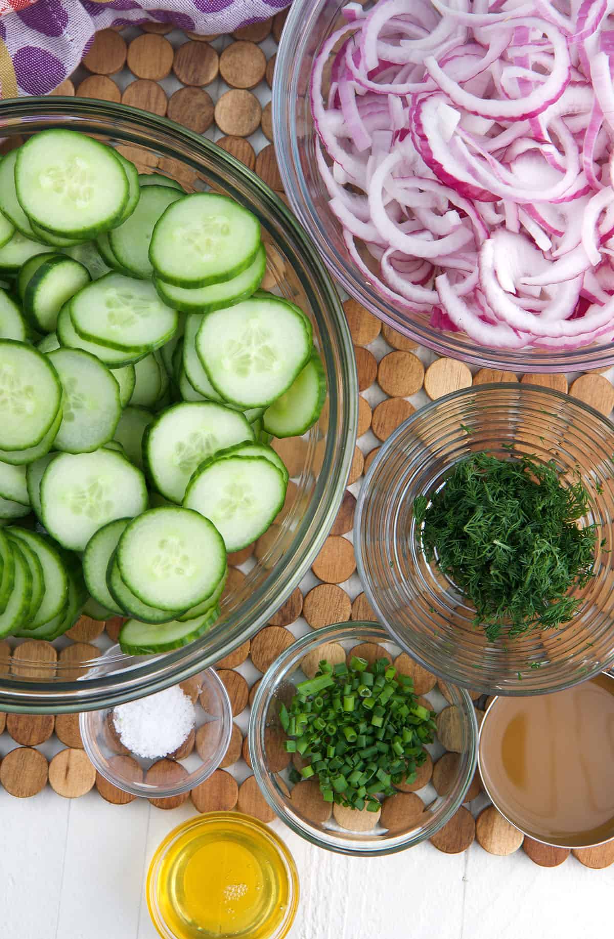 The ingredients for cucumber onion salad are spread out. 