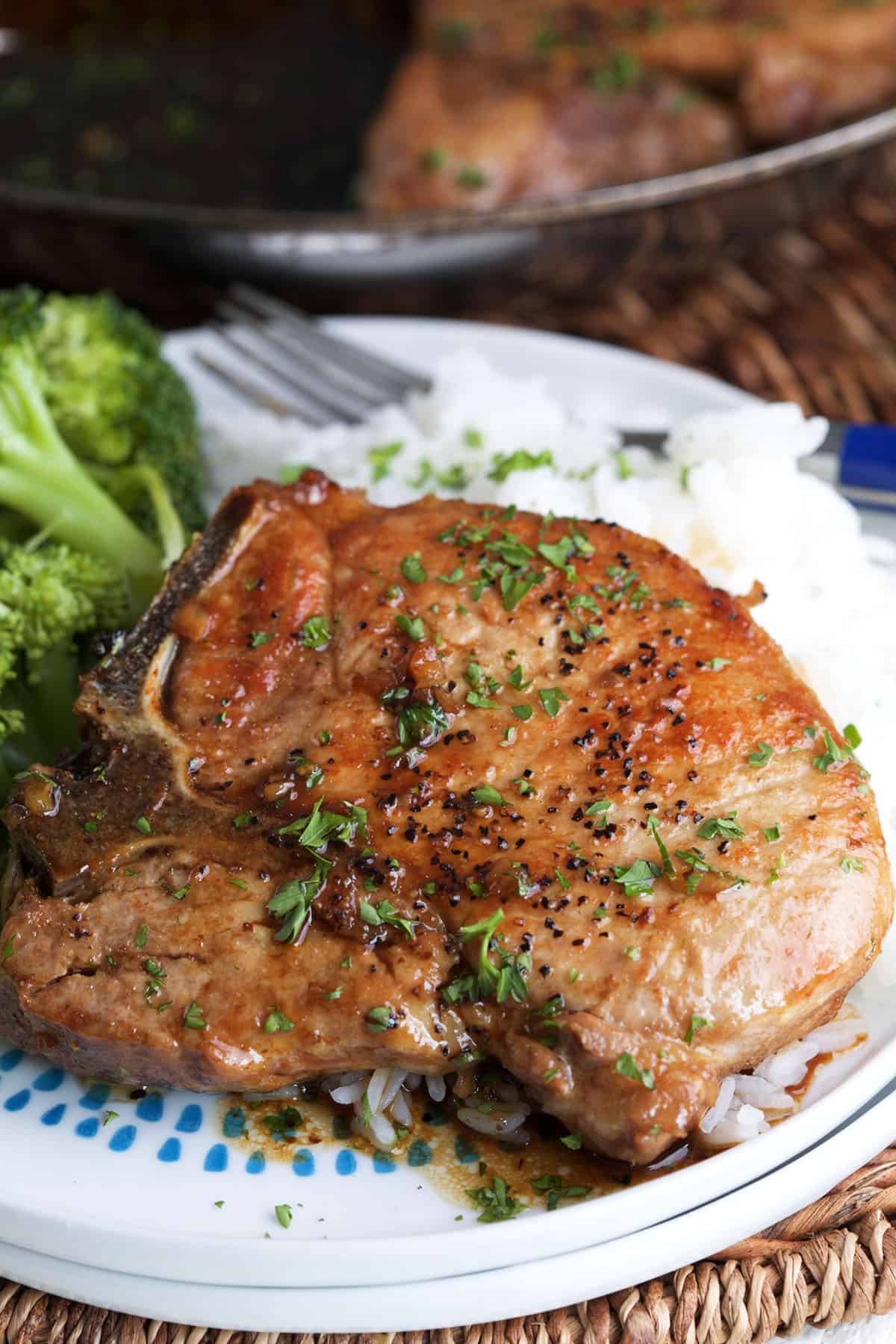 A plate is topped with pork chops and sides. 