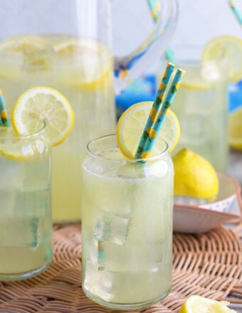 3 glasses of lemonade on a wicker placemat.
